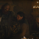 A scene from Game of Thrones in which a coffee cup is visible in the background